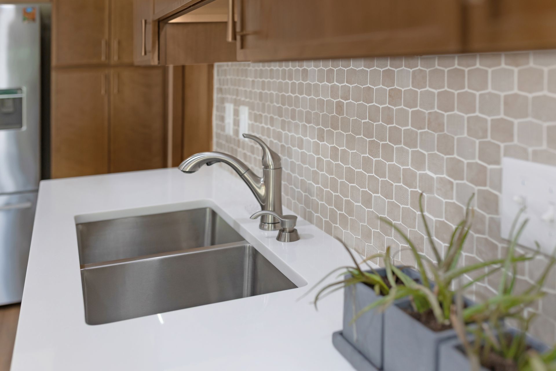 Perla White Countertops and Waypoint Cabinetry in Cherry Amber