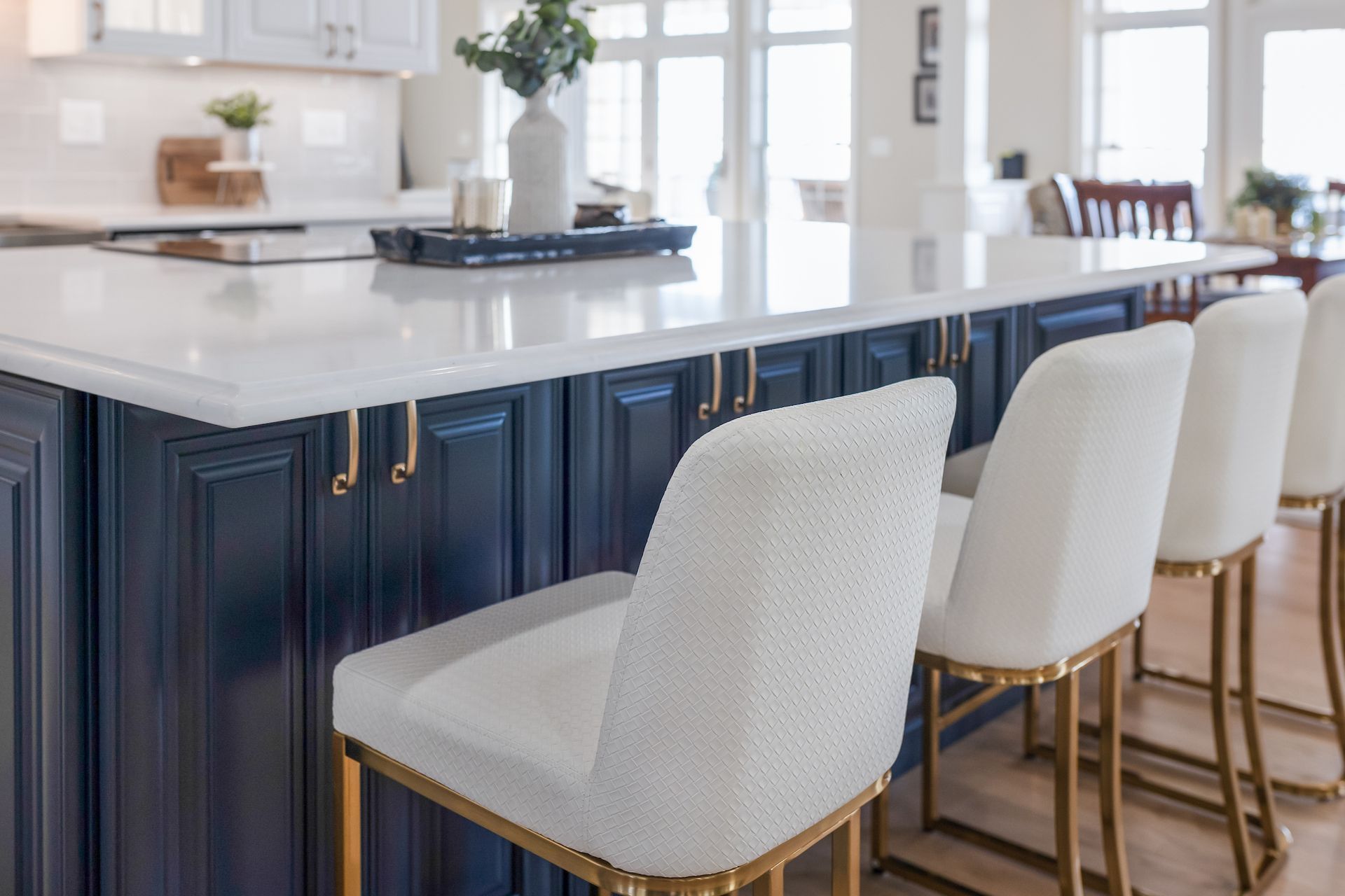 Calacatta Miraggio Cielo Q Quartz Countertops and Painted Navy Island Cabinets