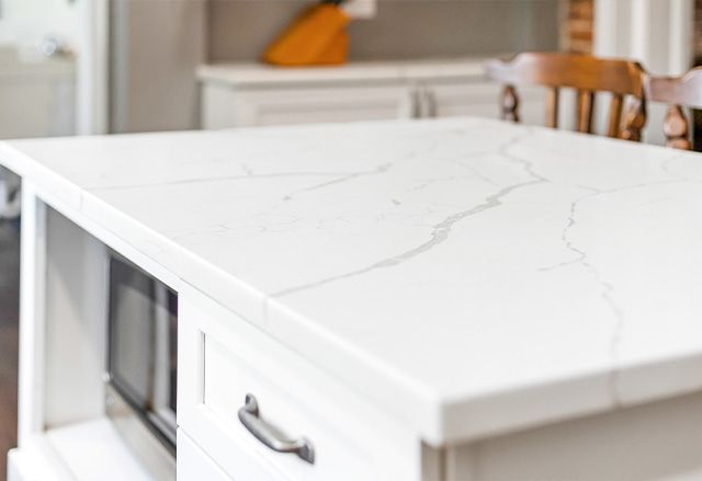 Calacatta Laza Q Quartz Countertop and Waypoint Painted Linen Island Cabinet