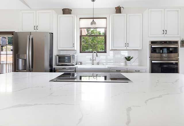 Waypoint Painted Pewter Cabinets and Calacatta Laza Q Quartz Countertops and Highback
