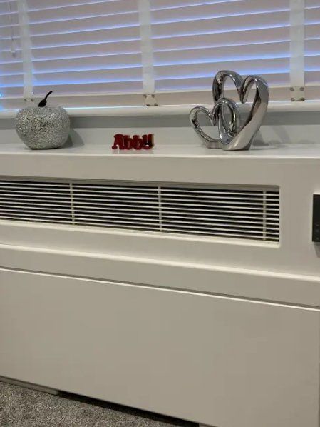 White radiator with decorations: apple, heart, nameplate