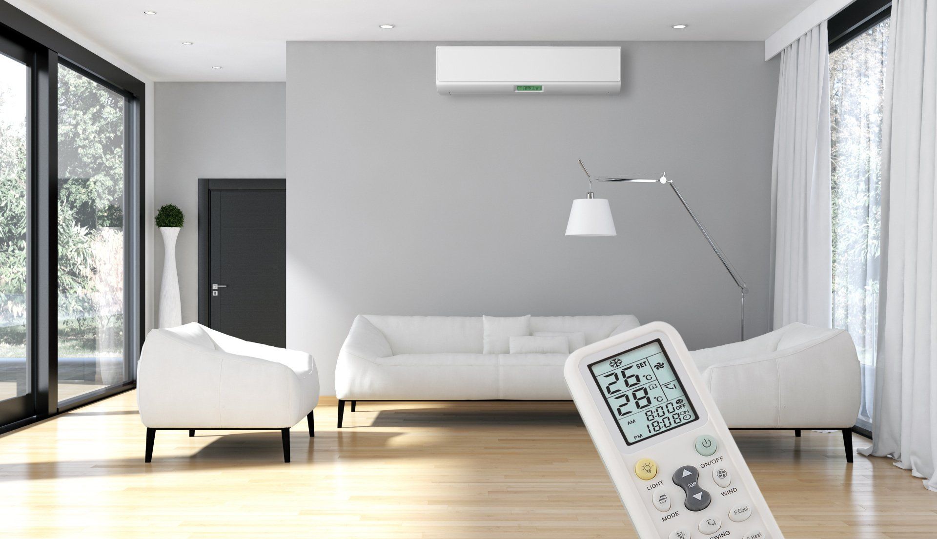 Living room with AC unit, white furniture, and remote control in focus.