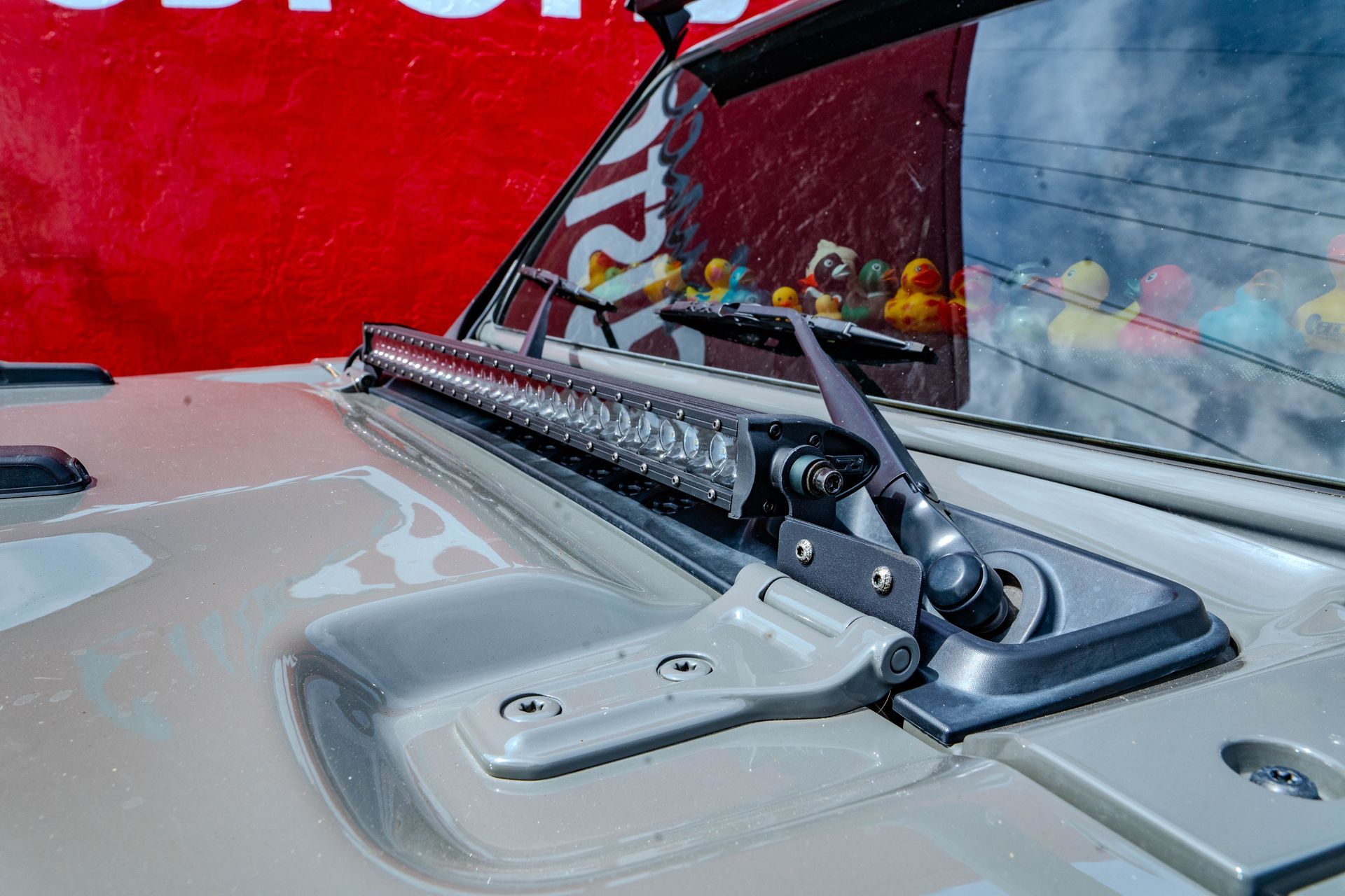 A close up of the hood of a jeep with a light on it.