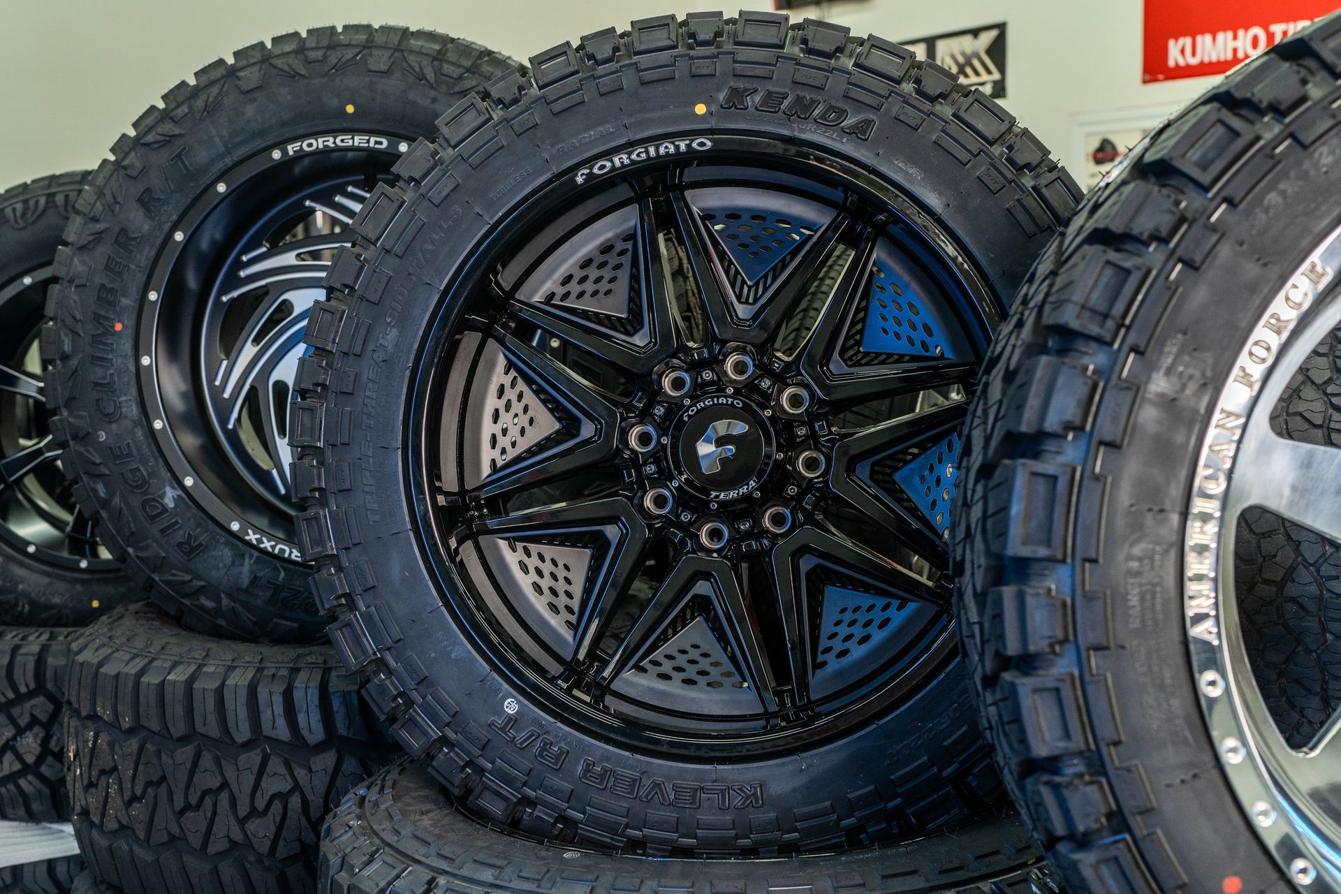 A pile of tires and wheels are stacked on top of each other.