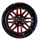 A close up of a red and black wheel on a white background.