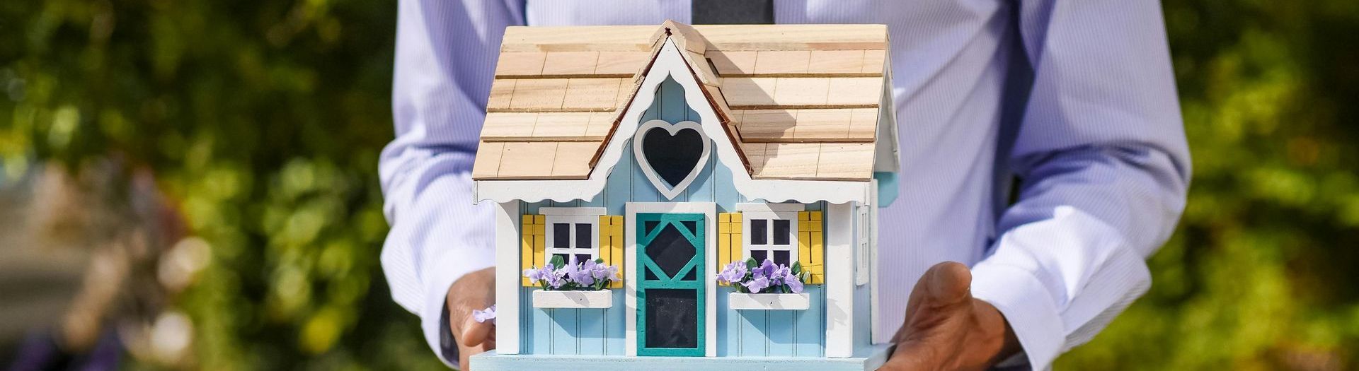 Realtor holding a model house