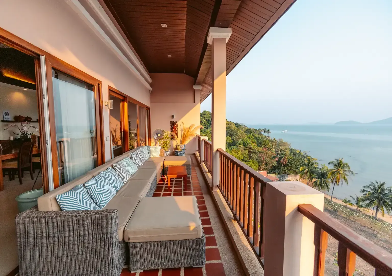 There is a large balcony with a view of the ocean.