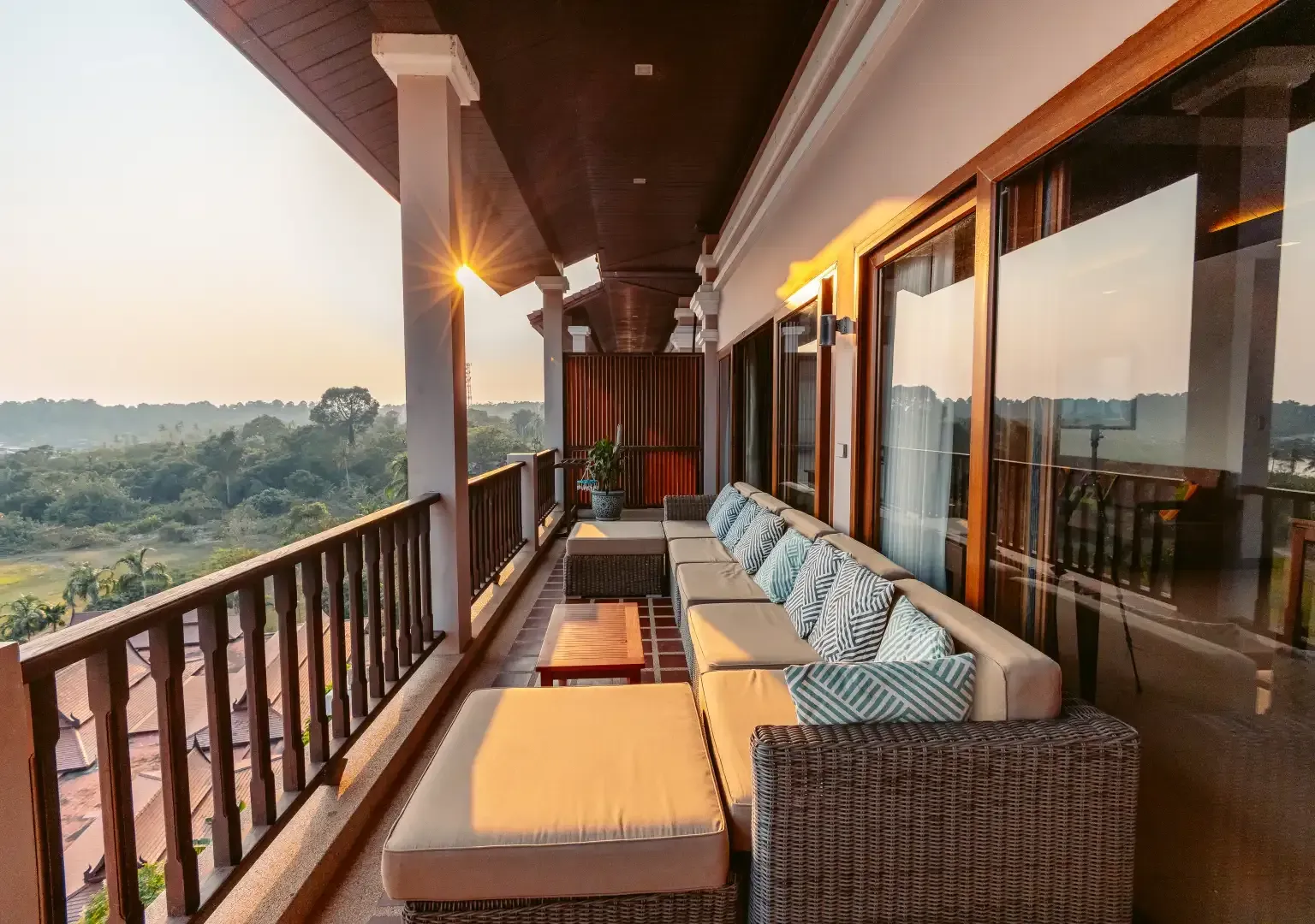 There is a large balcony with a lot of furniture on it.