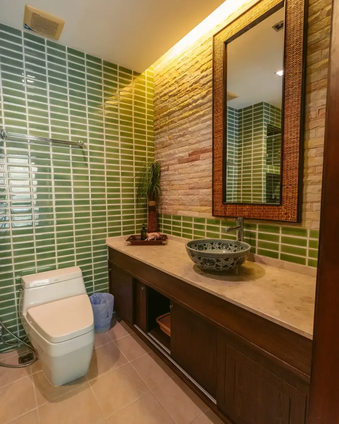 A bathroom with a toilet a sink and a mirror