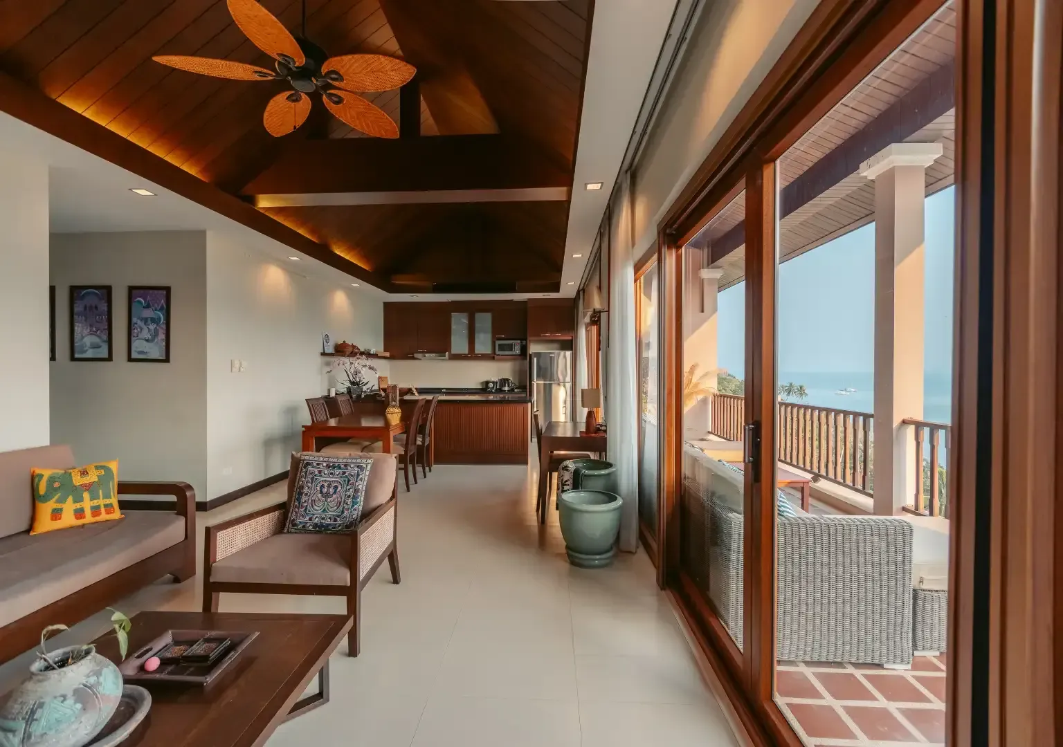 A living room with a ceiling fan and lots of windows