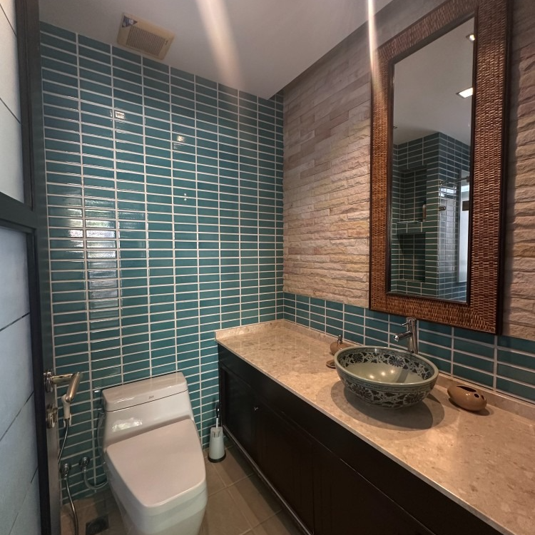 A bathroom with a toilet a sink and a mirror