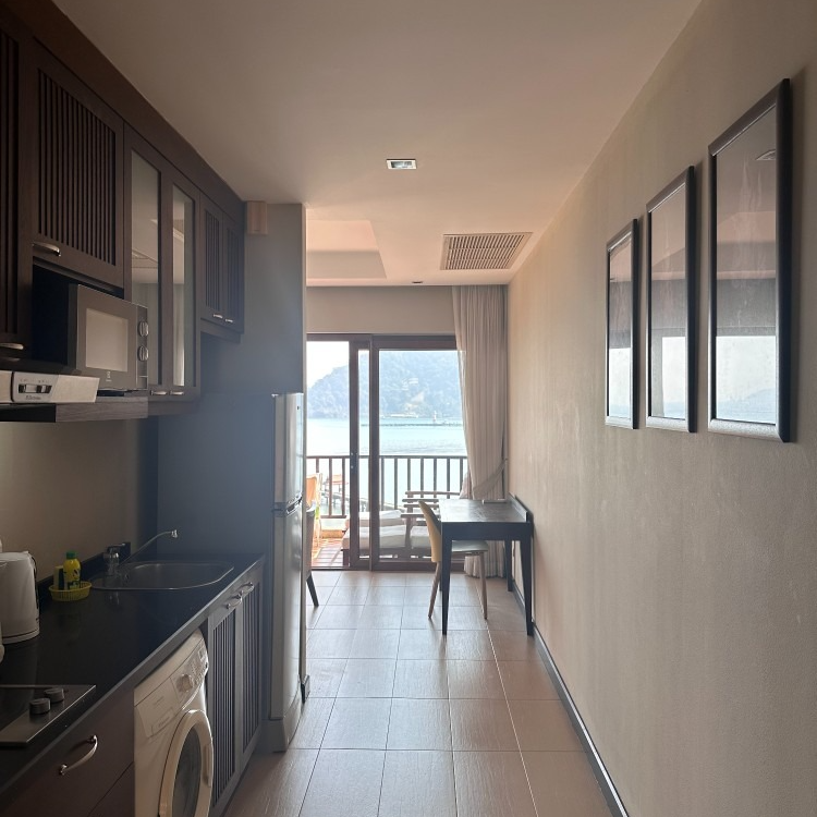 A kitchen with a stove top oven and a refrigerator
