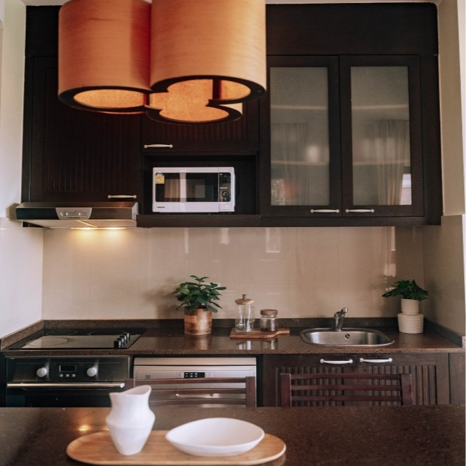 A kitchen with a stove a sink and a microwave