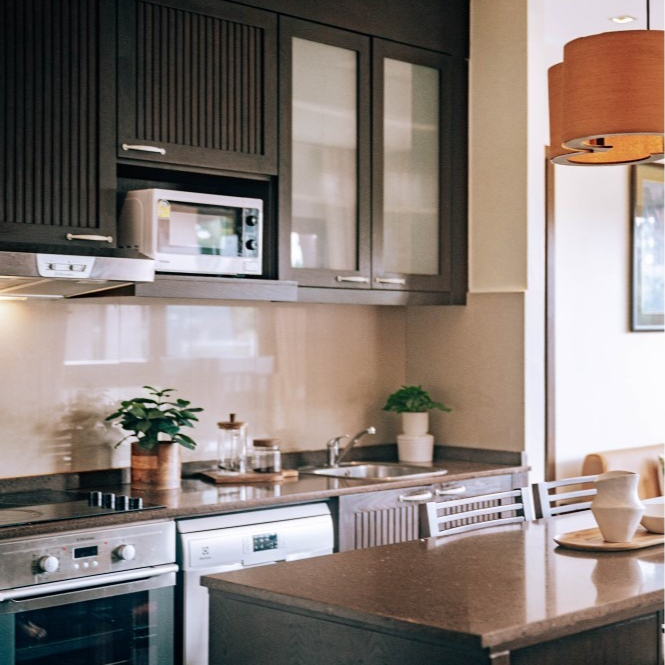 A kitchen with black cabinets and stainless steel appliances