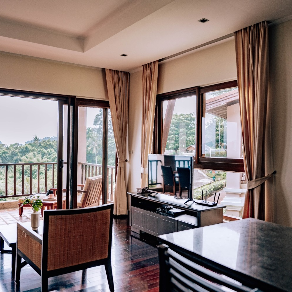 A living room with a table and chairs and a balcony