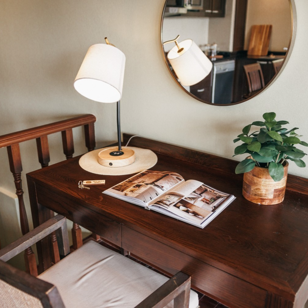 A desk with a lamp and a magazine on it