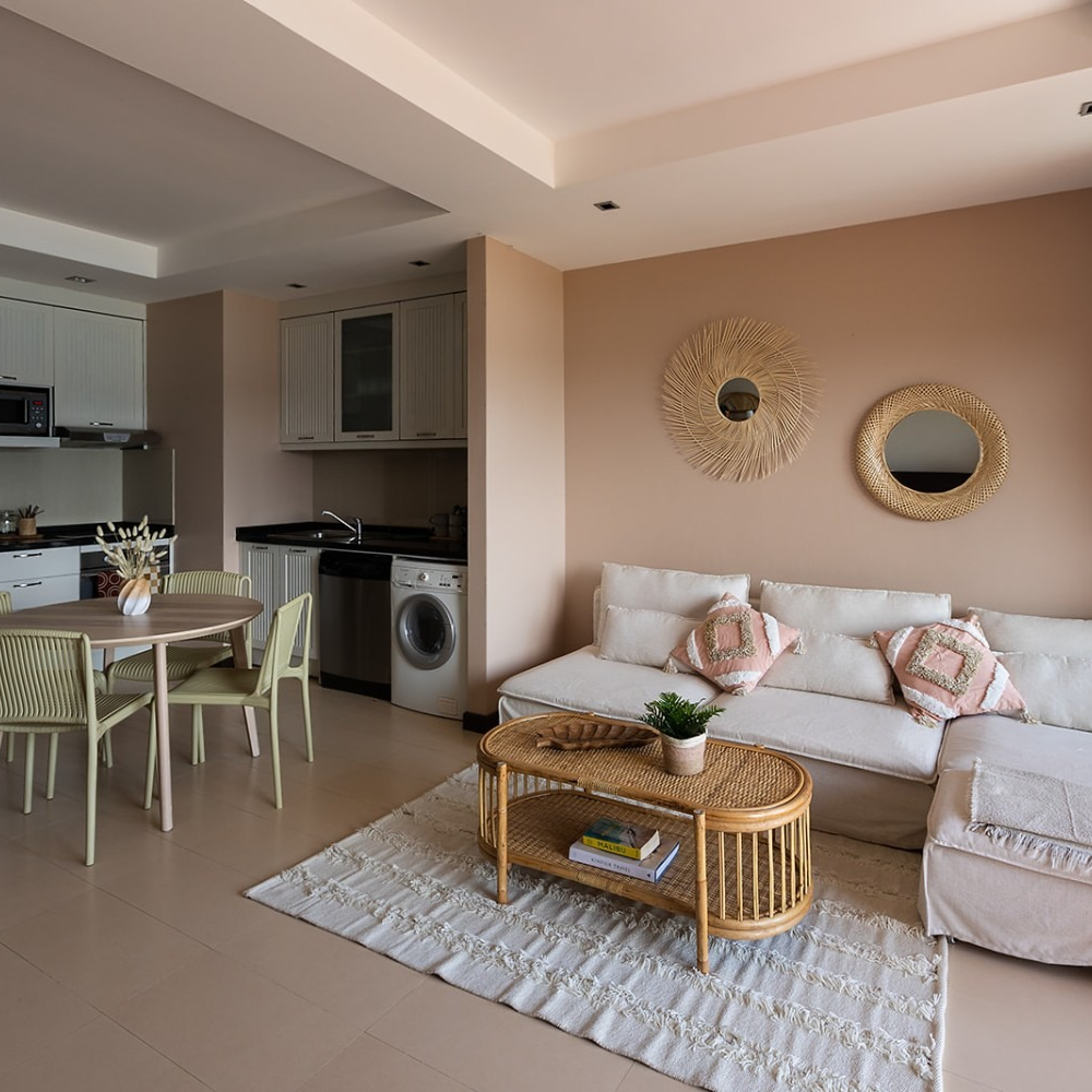 A living room with a couch a table and chairs