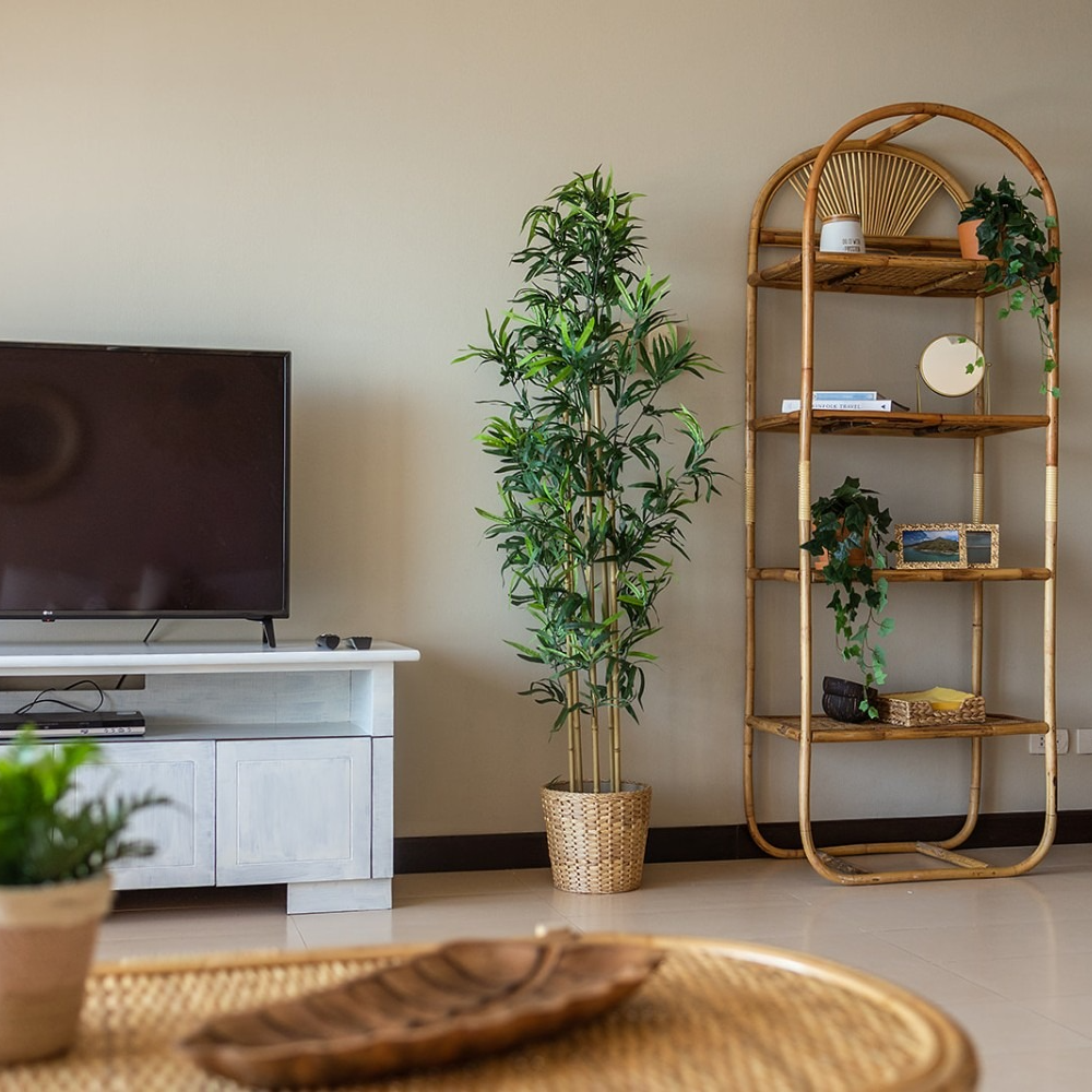 A living room with a tv and a wicker table