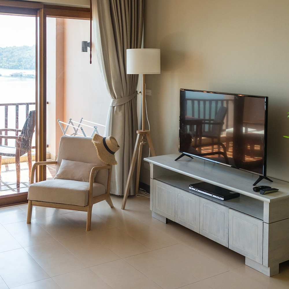A living room with a chair and a flat screen tv