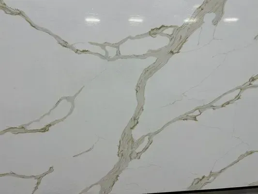 White surface with gold-colored veining, resembling marble or quartz.