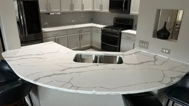 Kitchen with white cabinets, gray countertops, and a black stove.