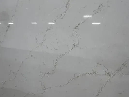 White marble surface with gray and gold veining.