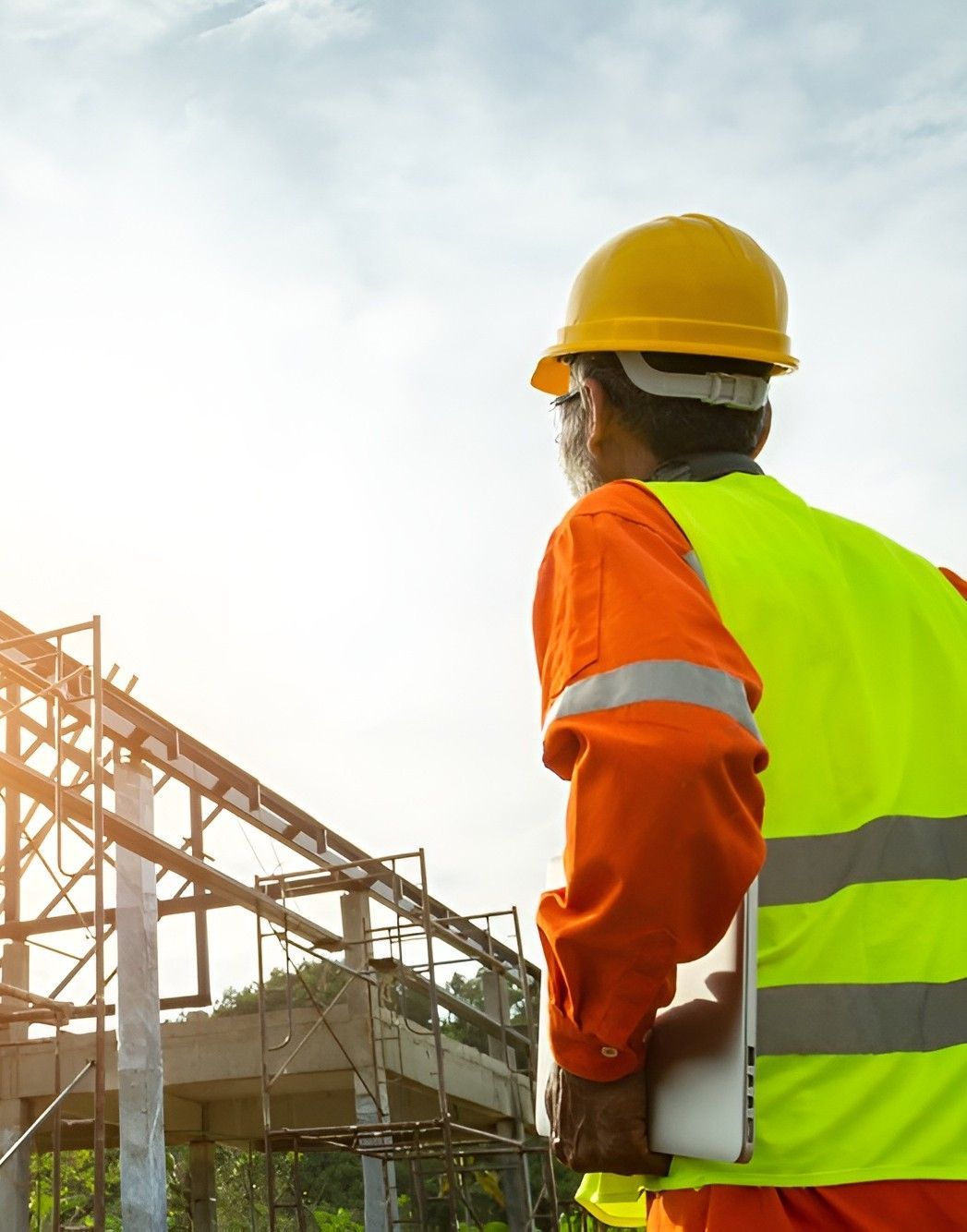 A Construction Worker Wearing a Hard Hat and Safety Vest — Premier Inspections FNQ In Cooktown, QLD