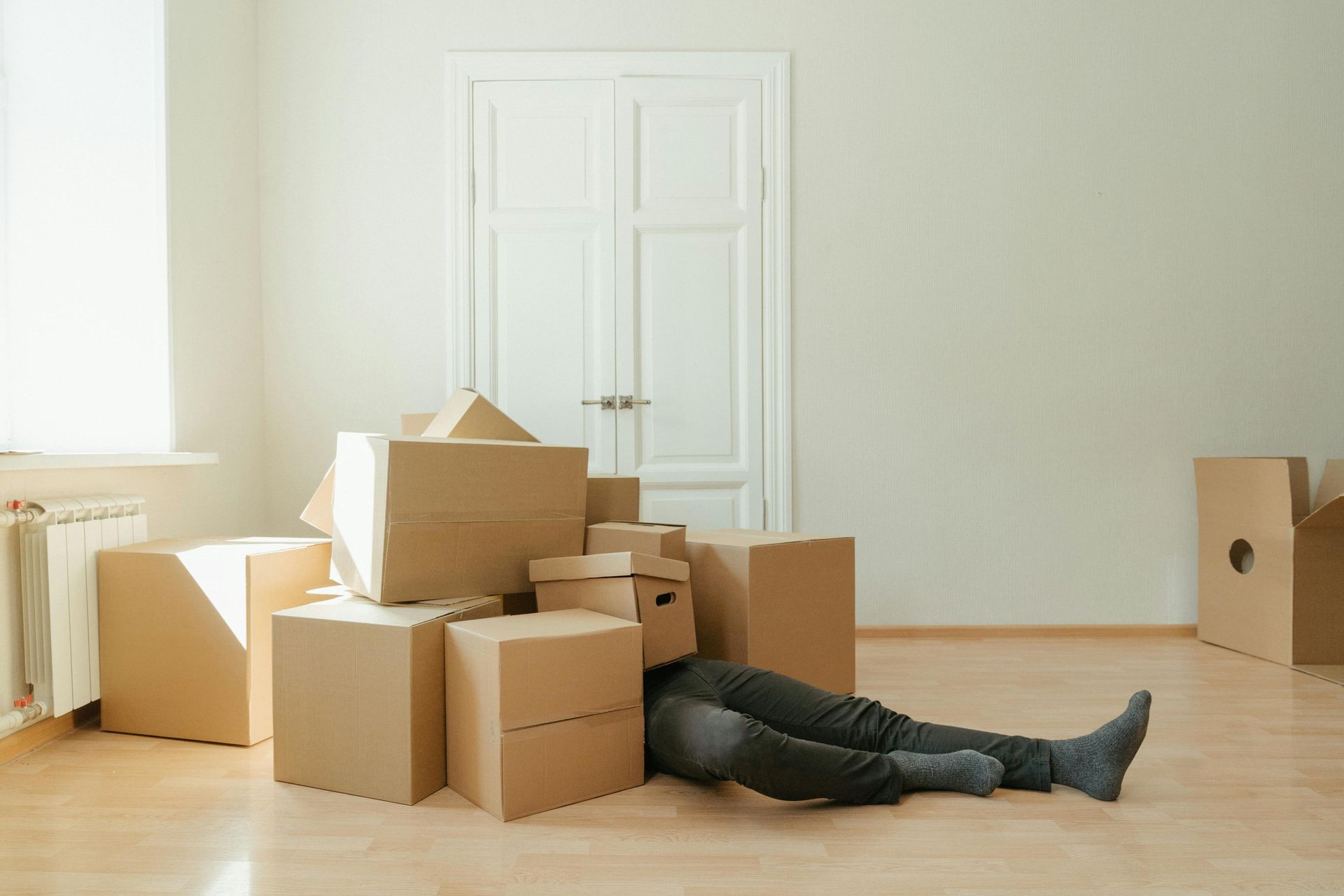 woman buried in moving boxes
