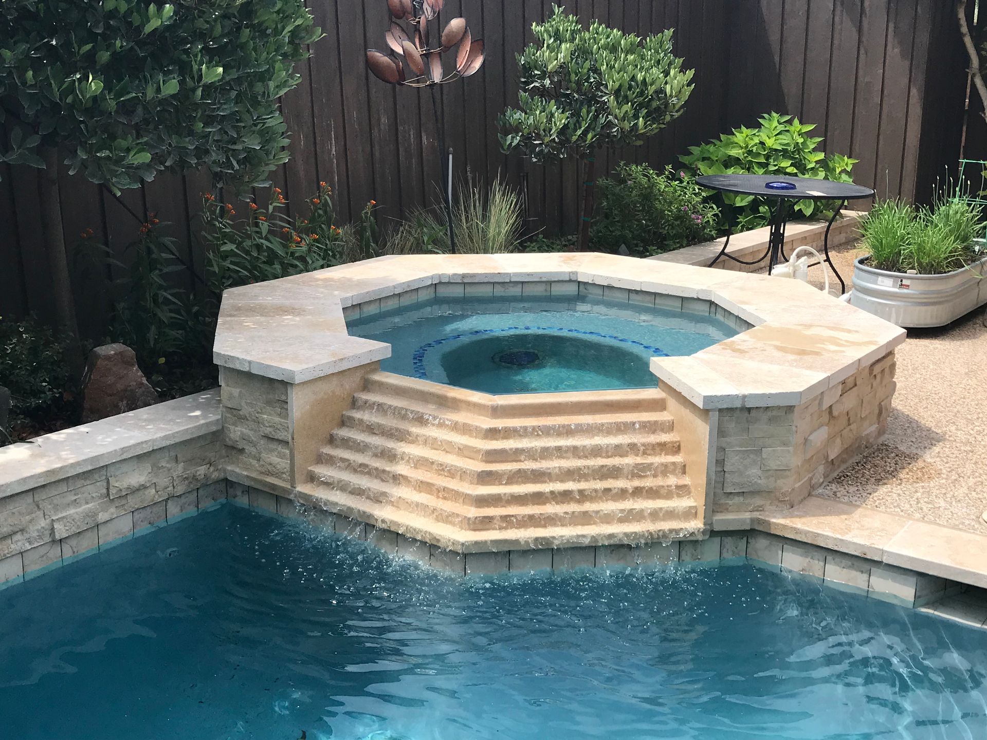 There is a hot tub in the middle of the pool.