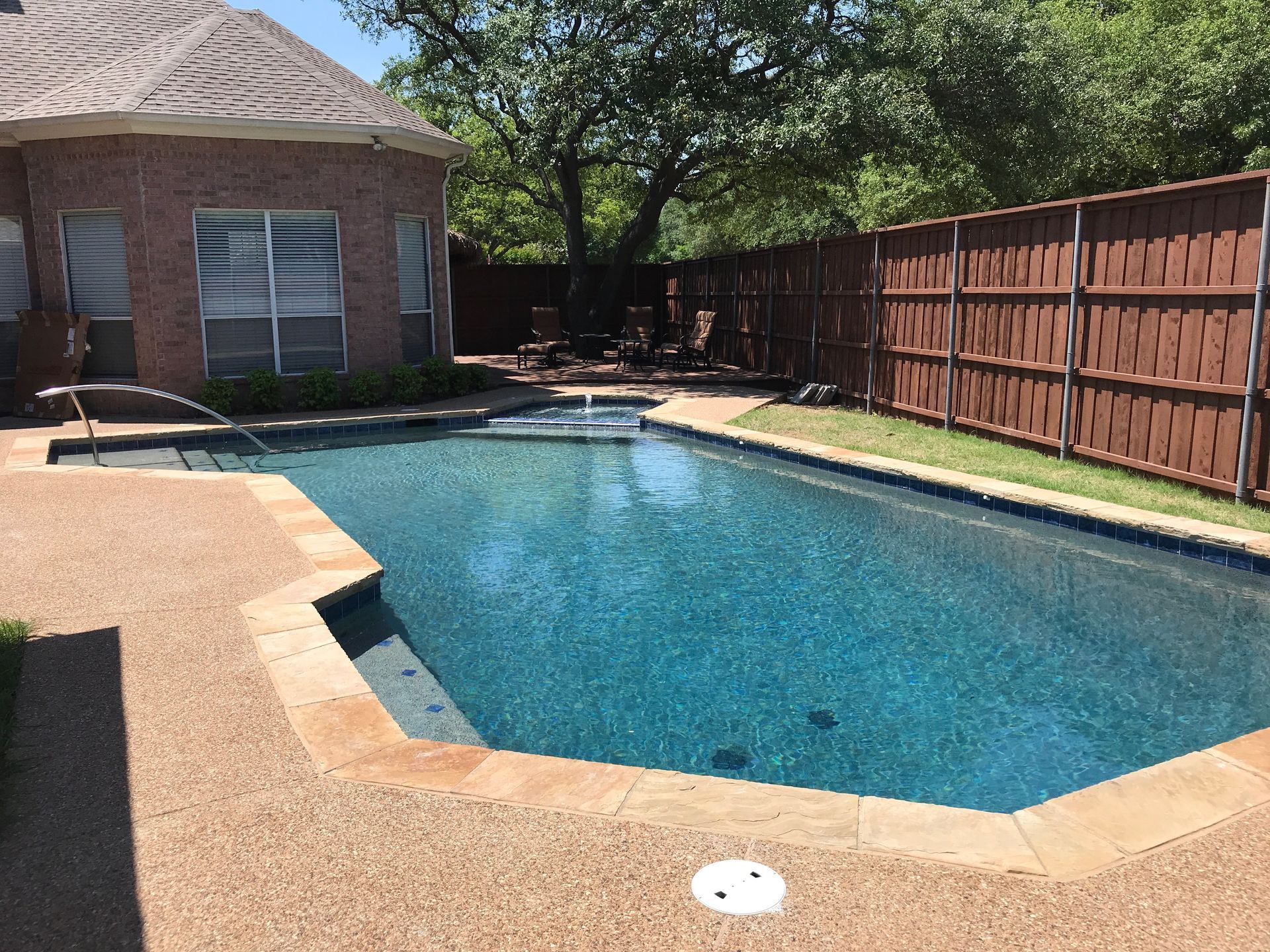 A large swimming pool in the backyard of a house