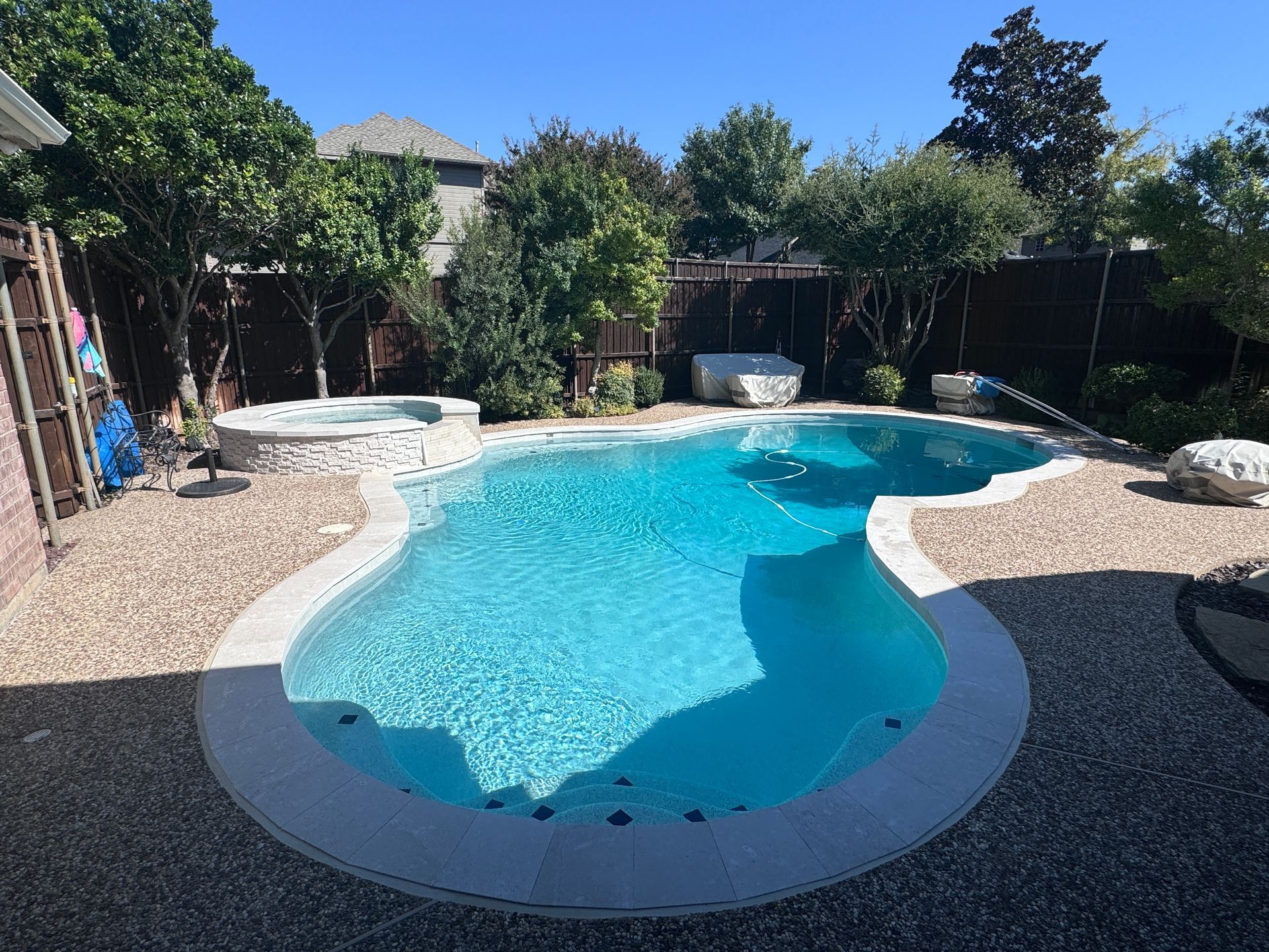 A large swimming pool in the backyard of a house