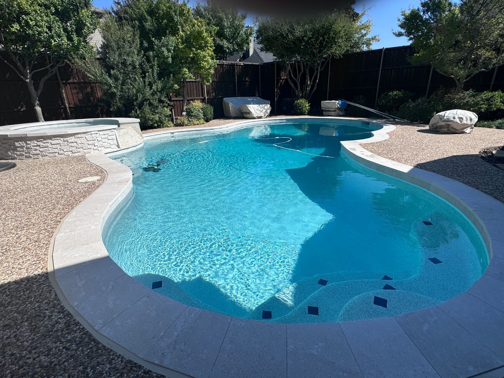 A large swimming pool in the backyard of a house