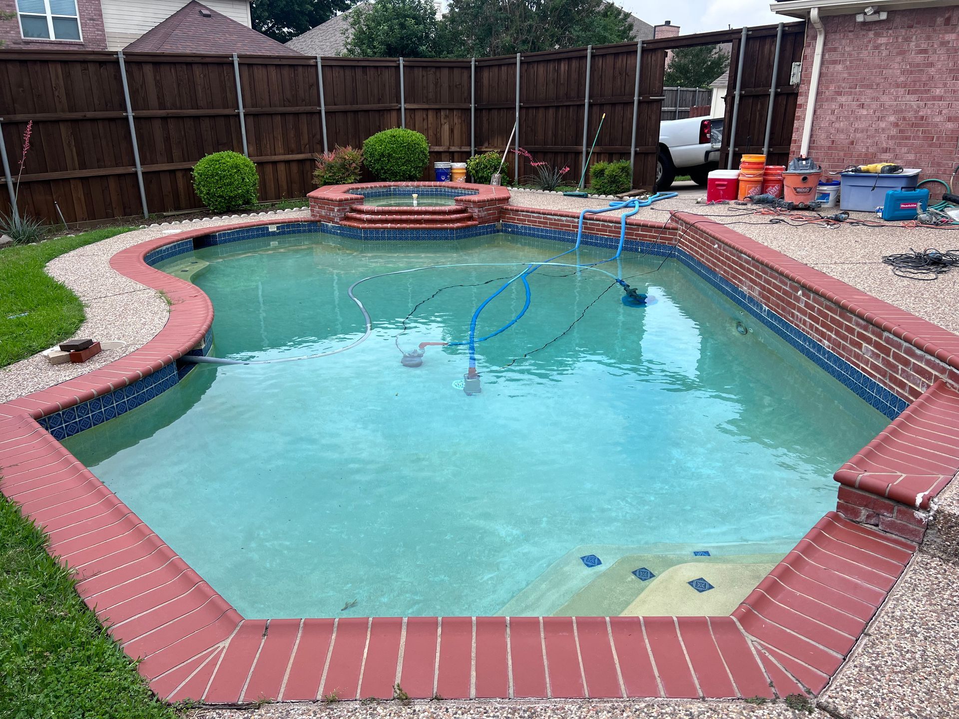 A large swimming pool with a fence in the background