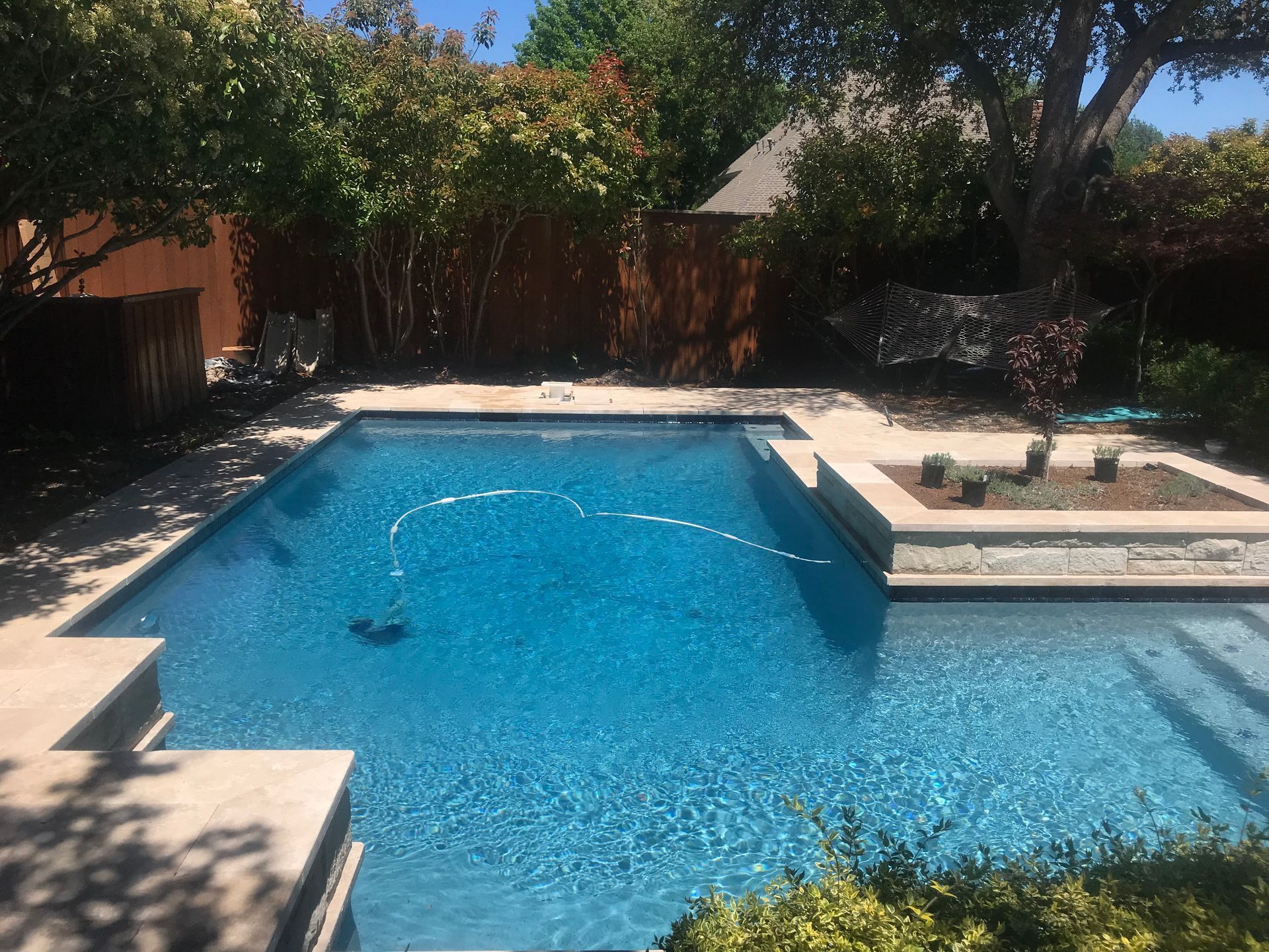 A large swimming pool in the backyard of a house
