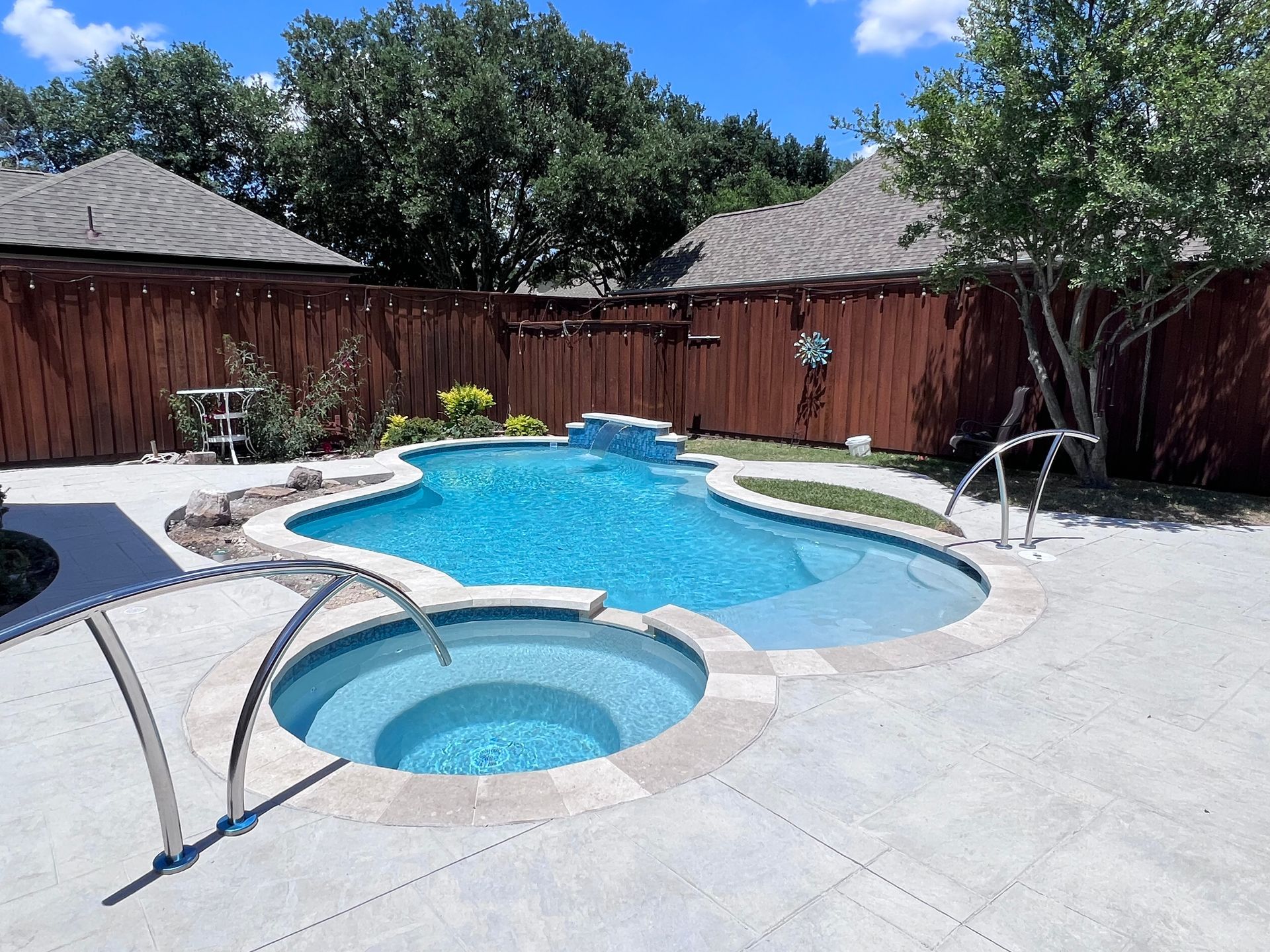 A large swimming pool with a hot tub in the middle