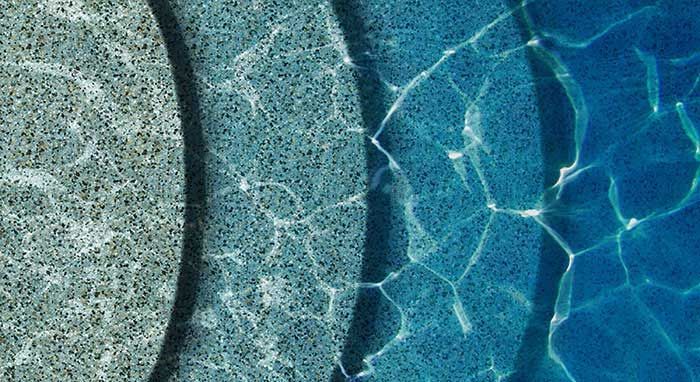 A close up of a swimming pool with different colored water.