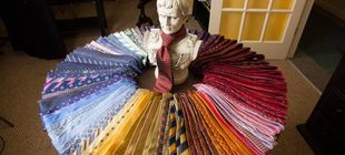 A statue of a man is surrounded by a circle of ties.