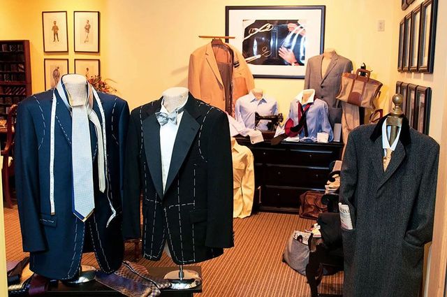 A room filled with mannequins wearing suits and ties