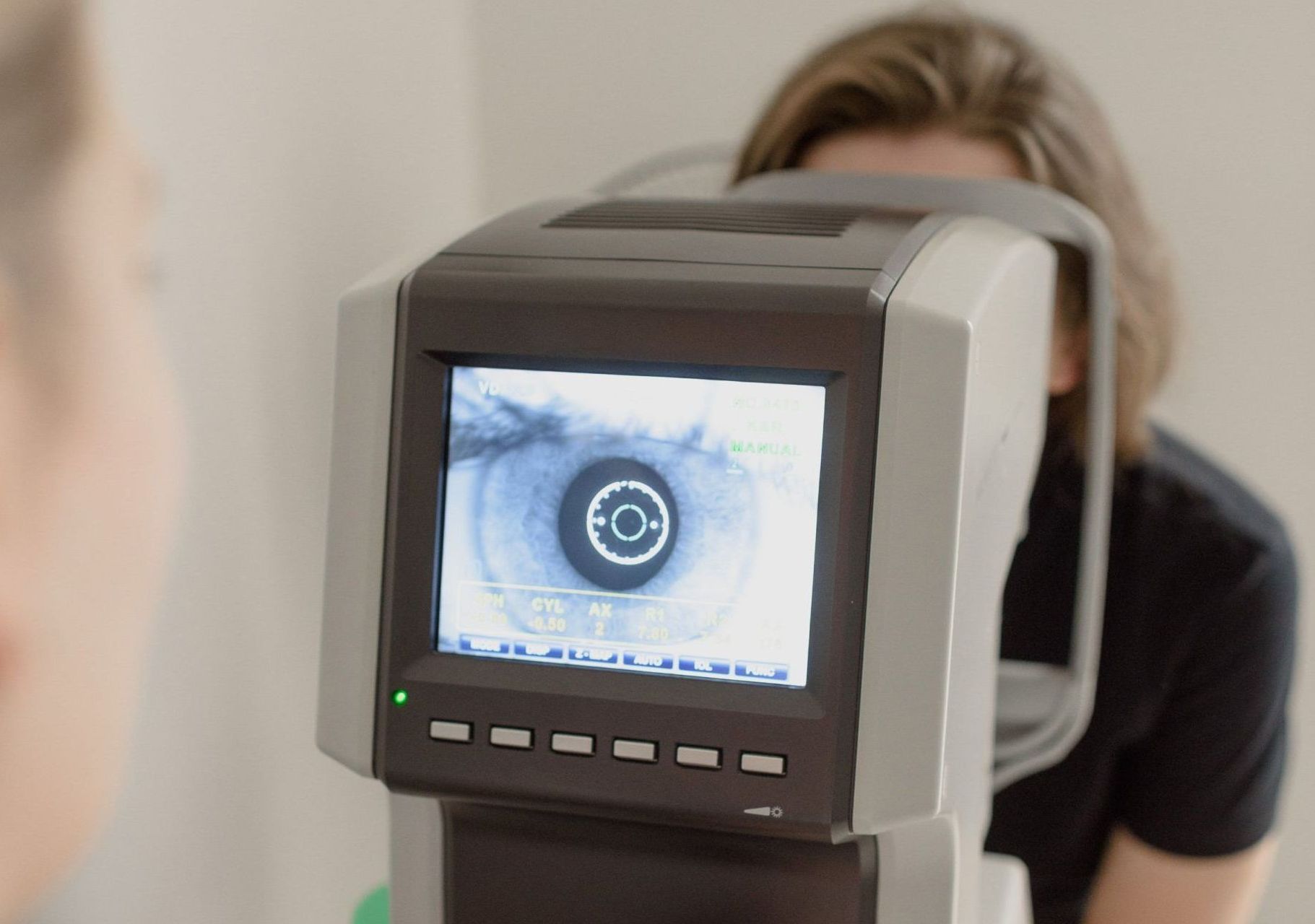 A woman is getting her eyes checked by an ophthalmologist.