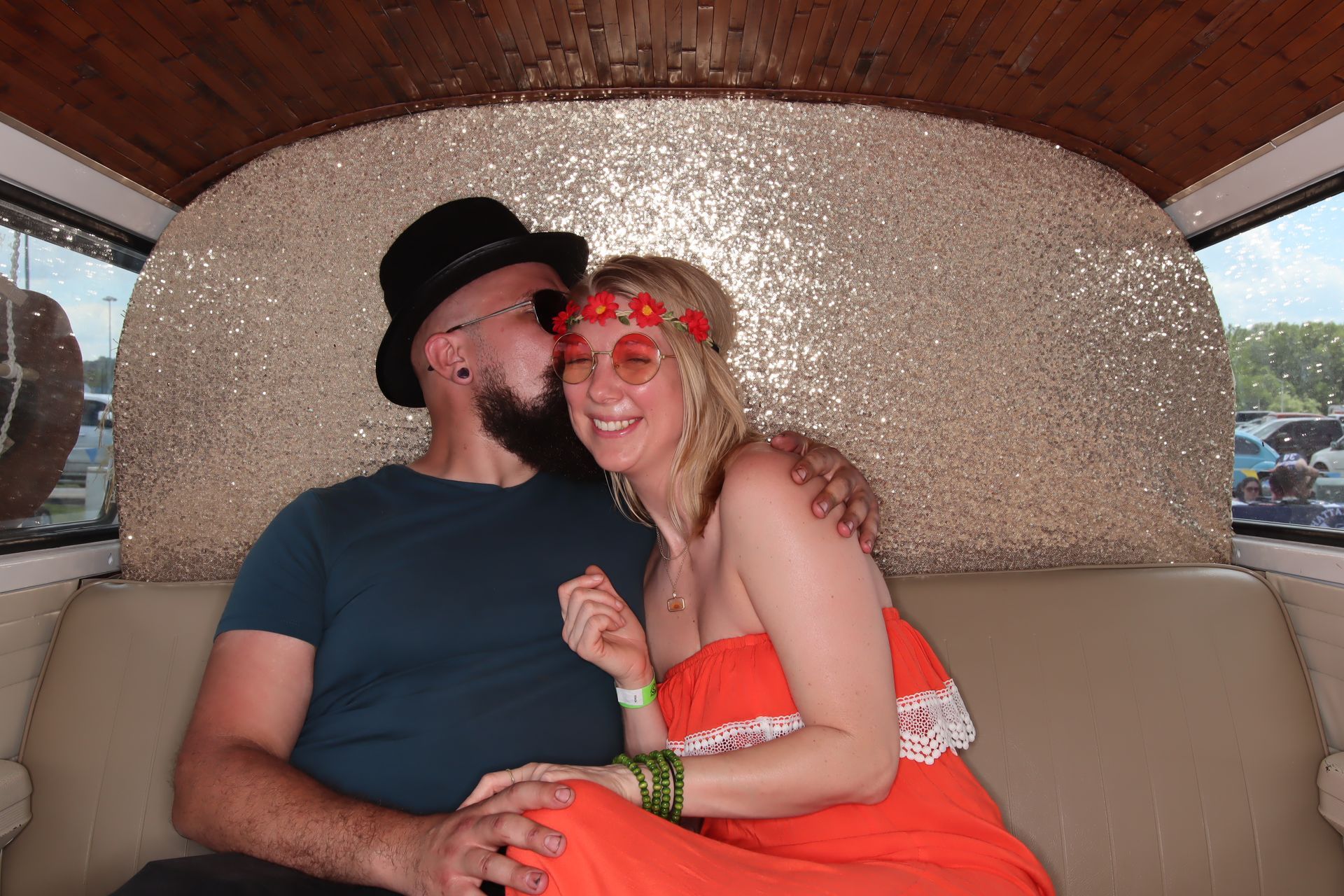 A couple takes photos inside the SunKissed Photo Bus Photo Booth in Chattanooga, TN