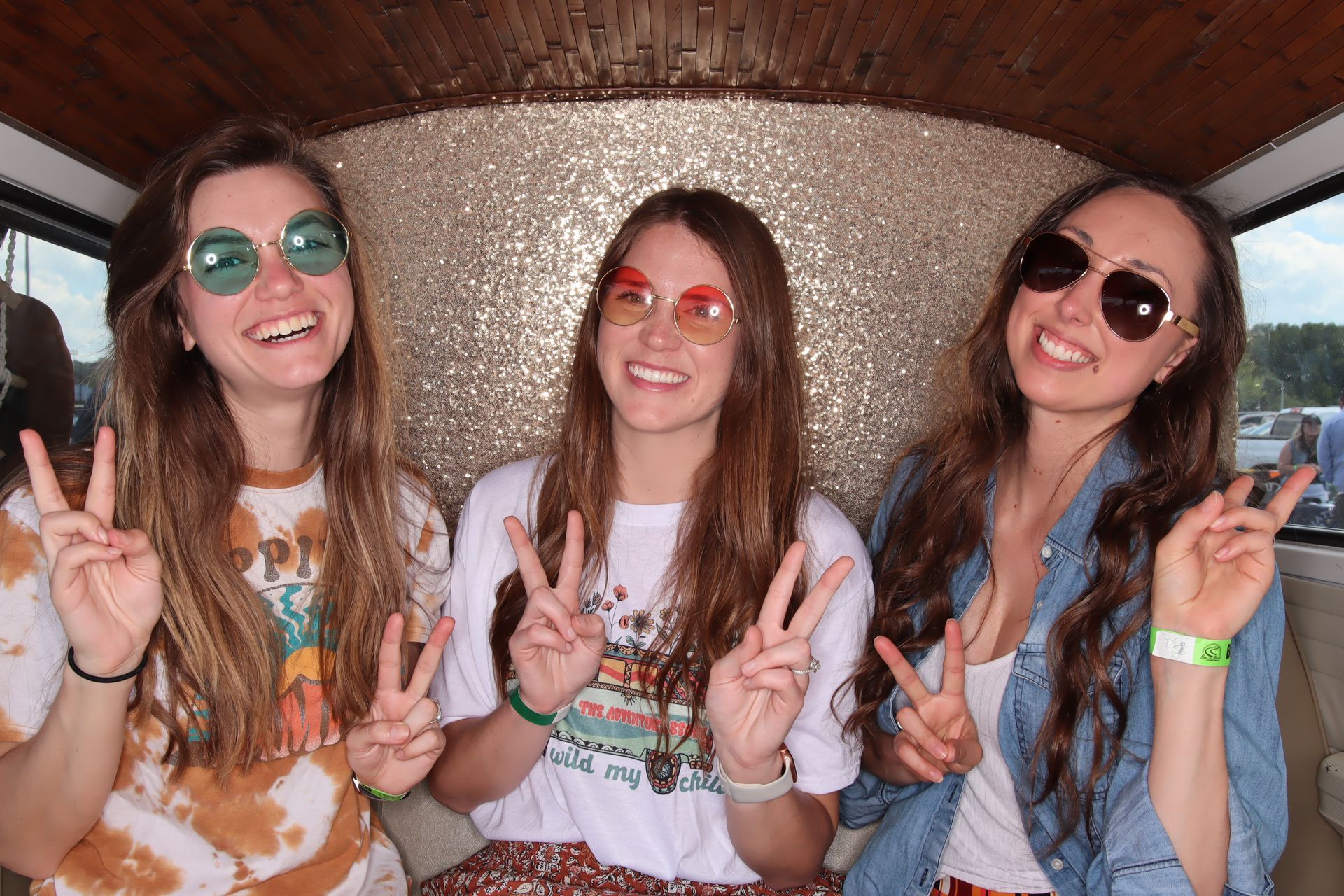 Three ladies take photos inside the SunKissed Photo Bus Photo Booth in Chattanooga, TN