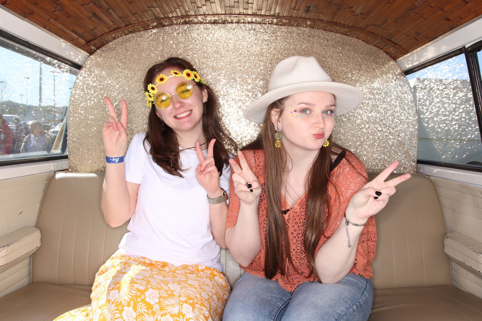 Two groovy ladies take photos inside the SunKissed Photo Bus Photo Booth in Chattanooga, TN