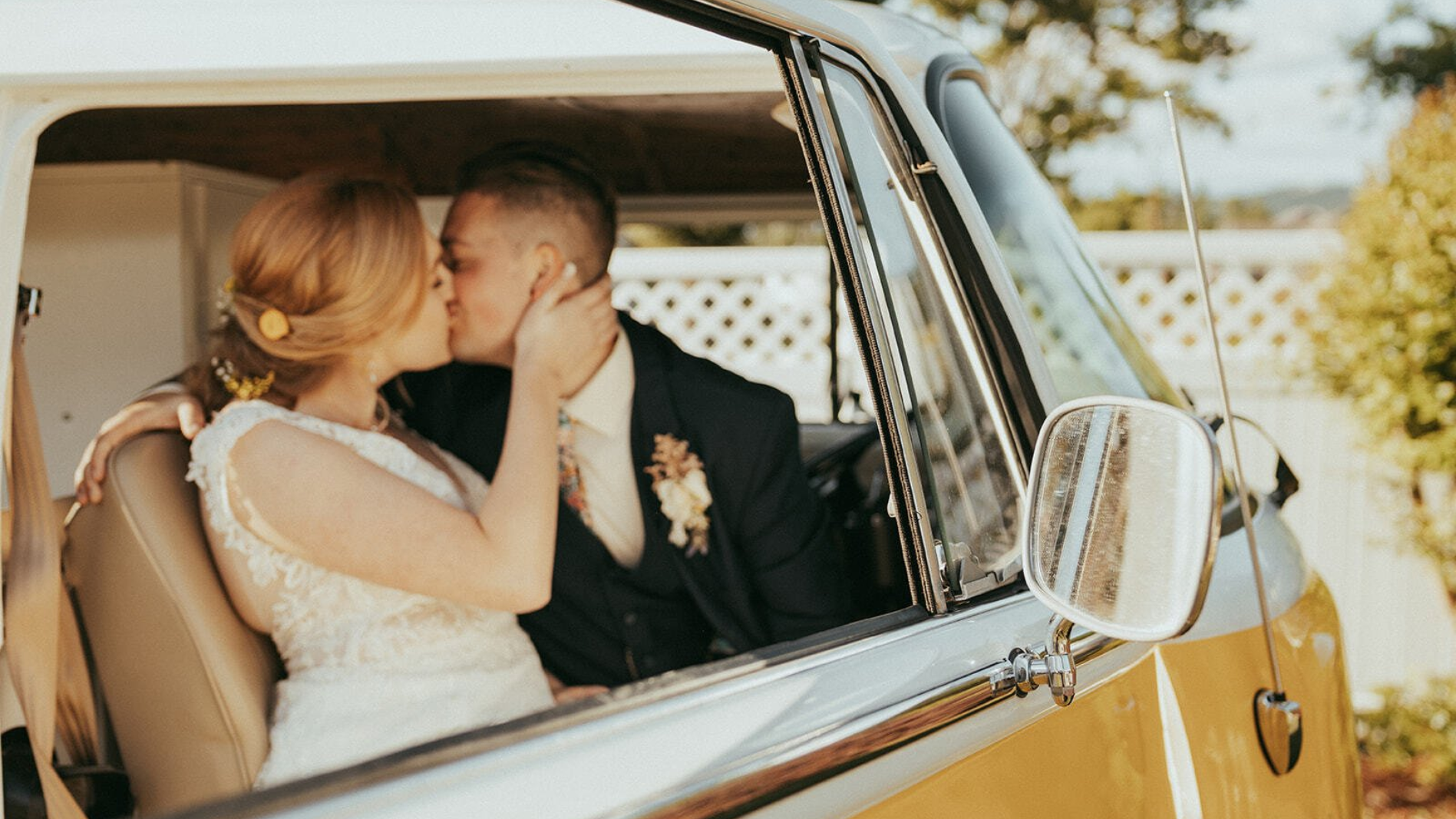 Bride and groom taking photos inside Miss Daisy from SunKissed Photo Bus at their wedding in Chattanooga, TN