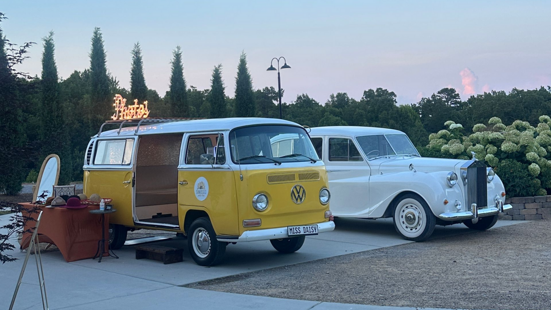 Miss Daisy from SunKissed Photo Bus parked next to a vintage car at Howe Farms