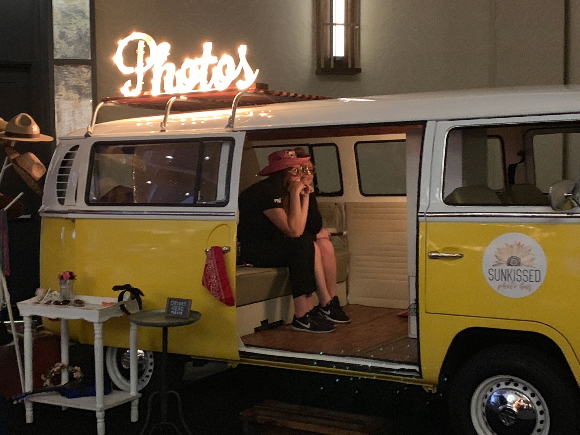 A yellow VW bus photo booth from SunKissed Photo Bus operating at the ballroom of the JW Marriott in Nashville, TN
