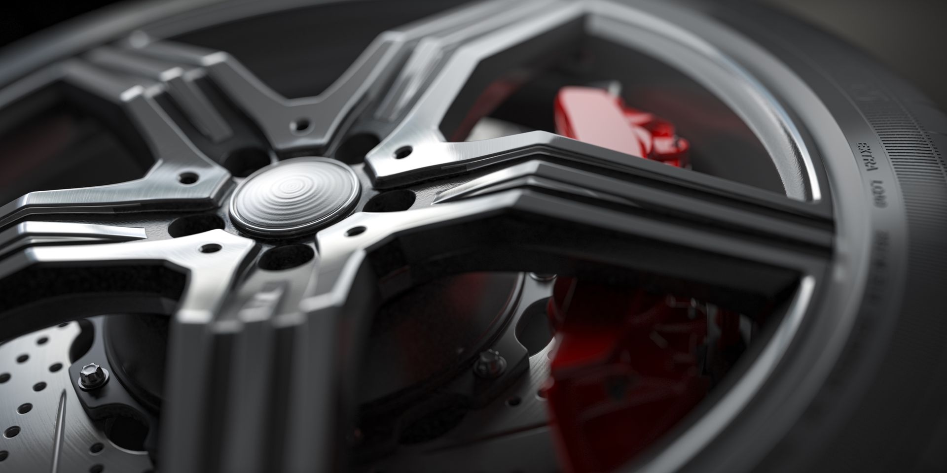 Close-up of a black-and-silver car wheel with red brake caliper and perforated rotor.