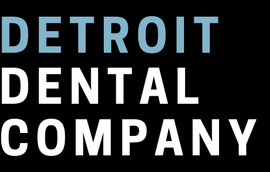 The detroit dental company logo is white on a black background.