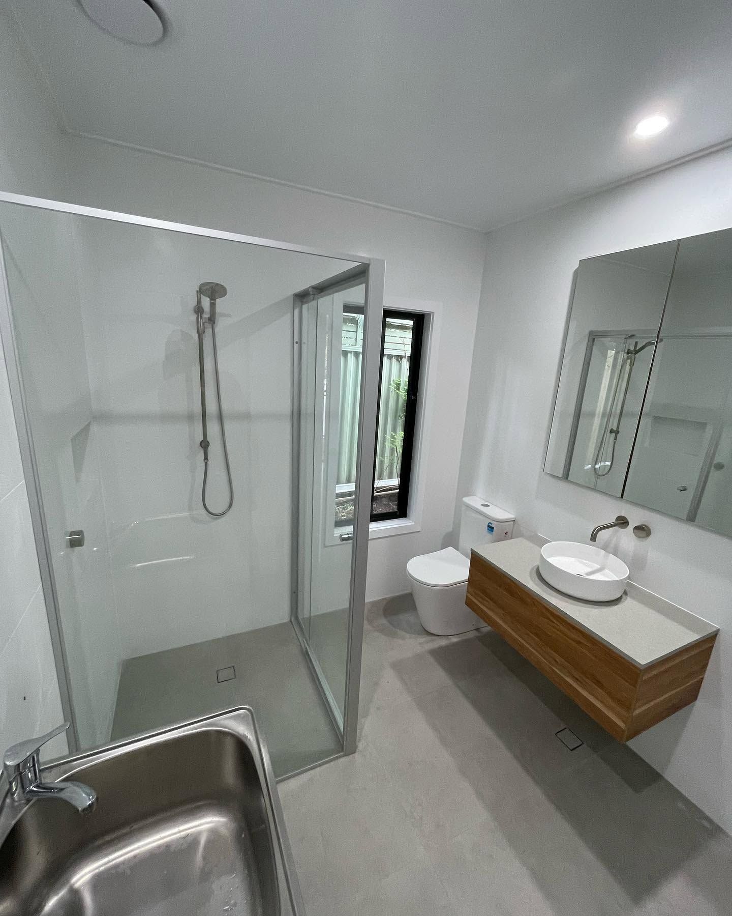 A Newly Renovated Bathroom With White Walls
