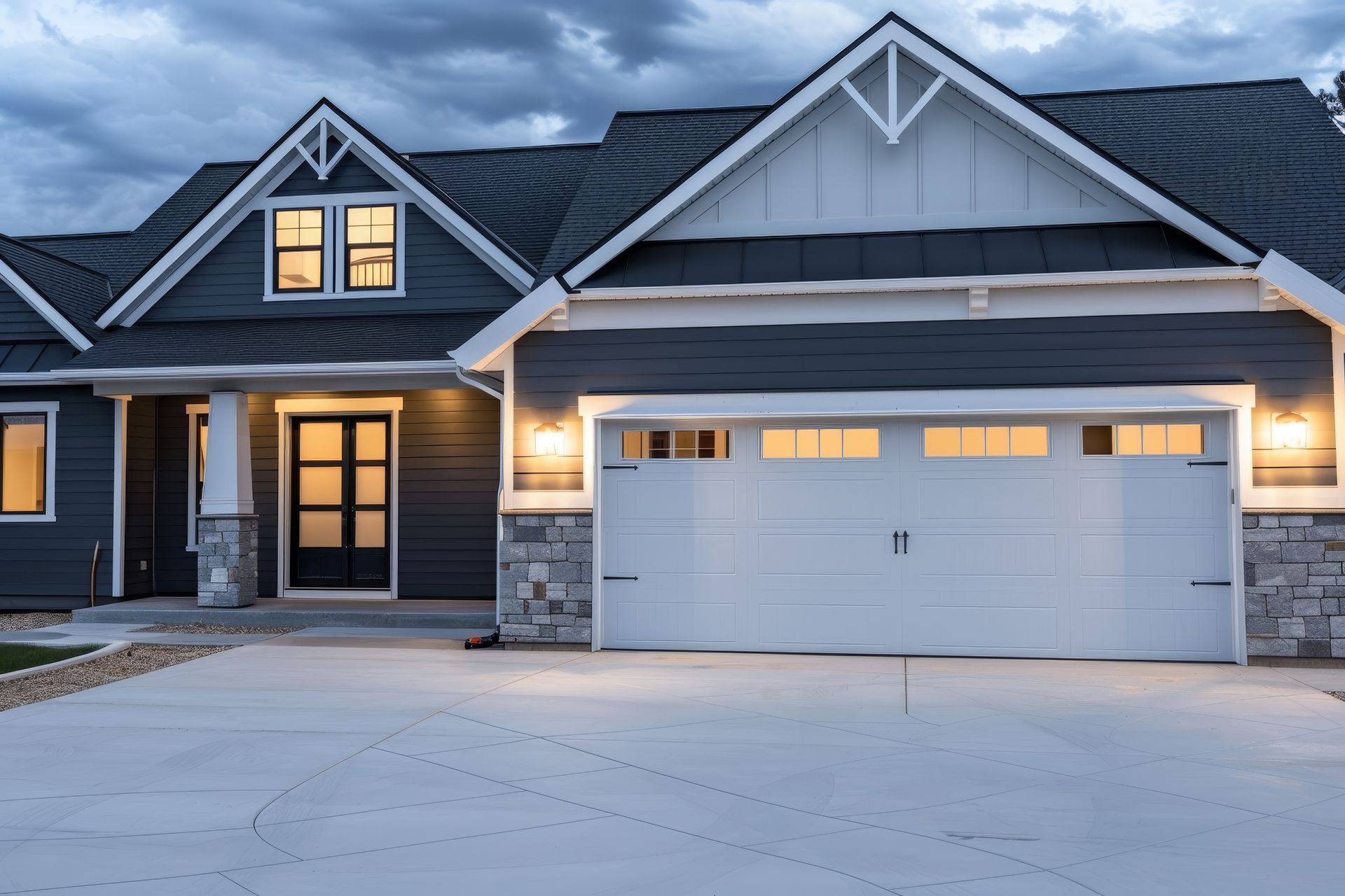 Modern farmhouse exterior showing a professional garage door installation service on a driveway.