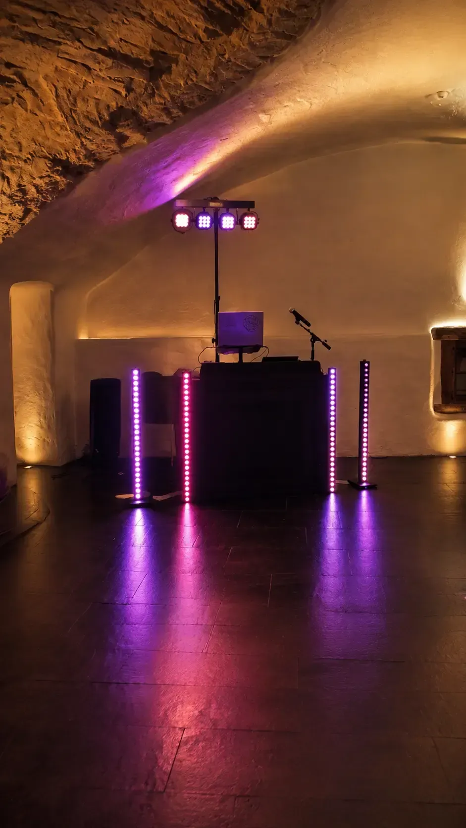 Kompaktes beleuchtetes DJ-Setup in einem Gewölbekeller